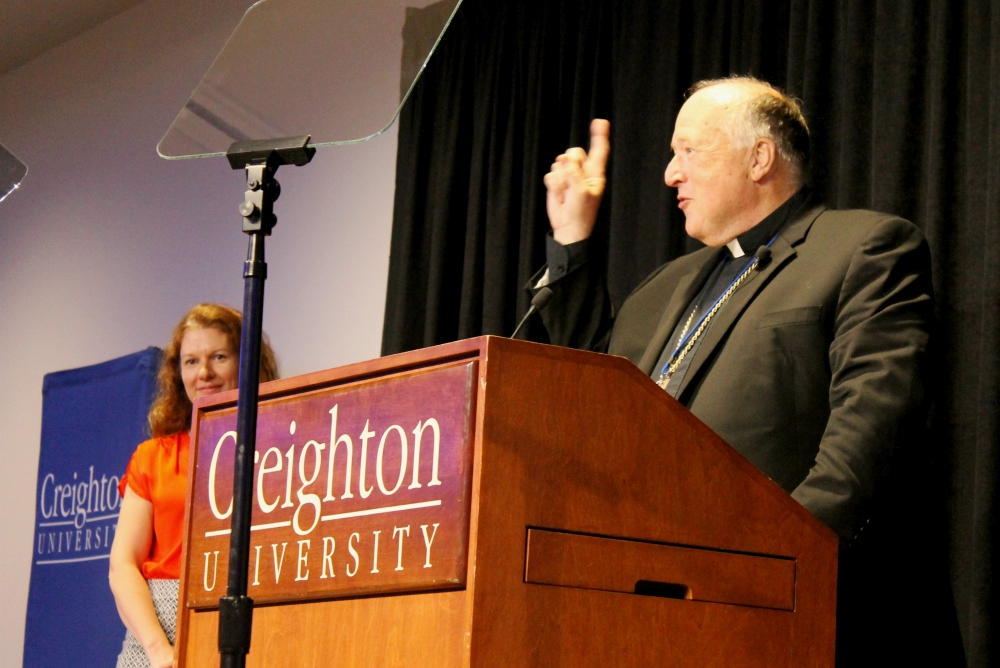 San Diego Bishop Robert McElroy counts down before he leads a sing-along of "God Bless America" during the inaugural "Laudato Si' and the U.S. Catholic Church" conference series June 27 at Creighton University in Omaha, Nebraska. (NCR photo/Brian Roewe) San Diego Bishop Robert McElroy counts down before he leads a sing-along of "God Bless America" during the inaugural "Laudato Si' and the U.S. Catholic Church" conference series June 27 at Creighton University in Omaha, Nebraska. (NCR photo/Brian Roewe)